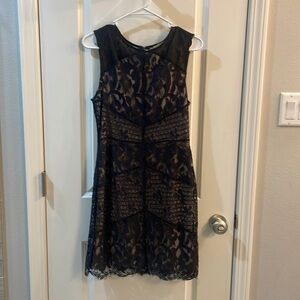 Black lace cocktail dress with tan lining.